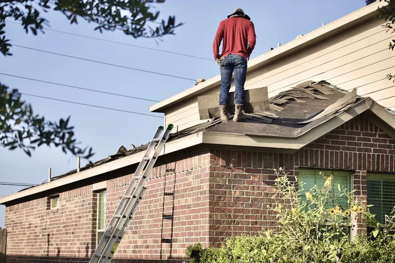 Professional roofer working on a residential roof in San Carlos Park